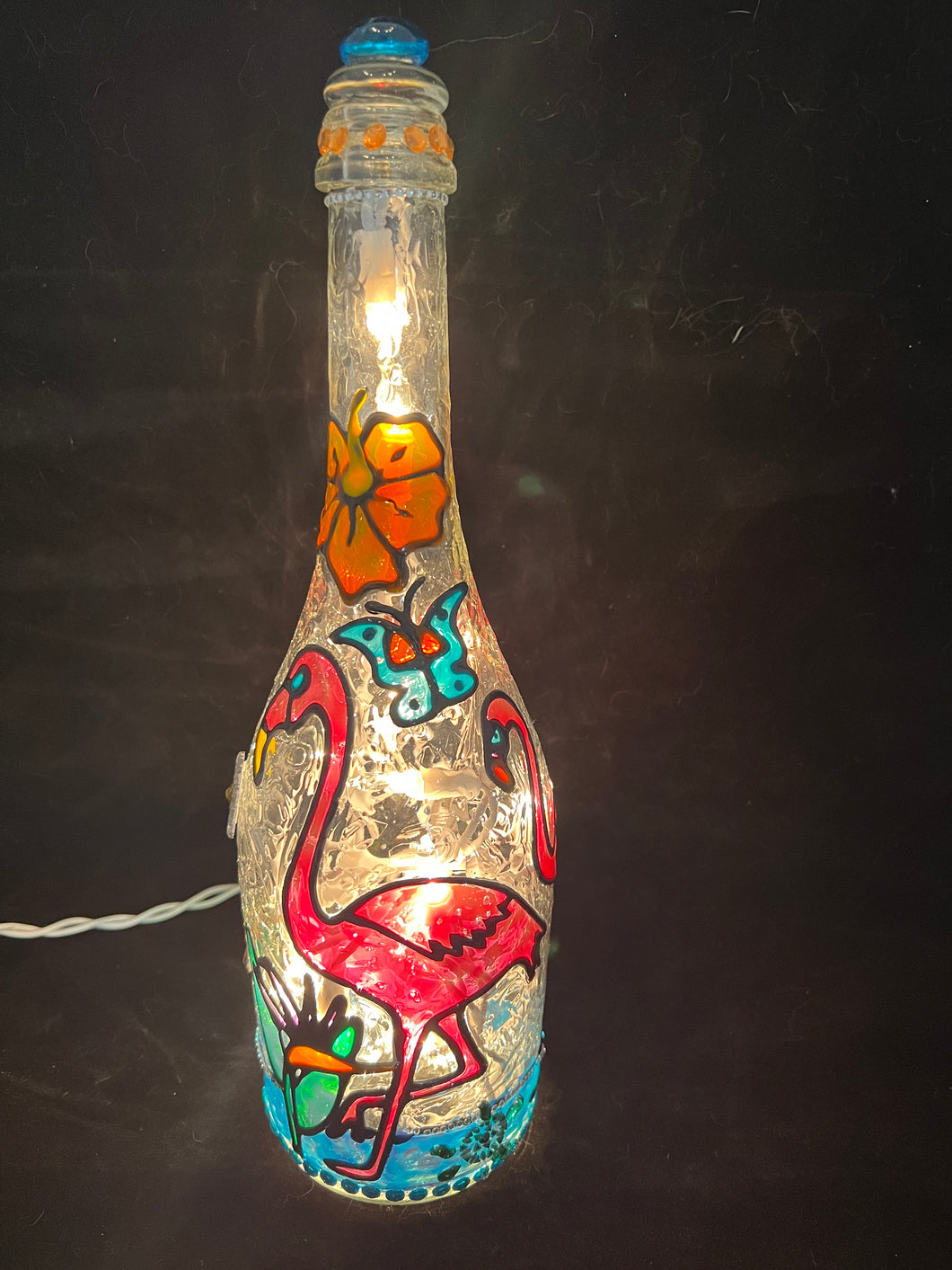 Champagne bottle with hand painted Flamingos, Bird of Paradise and hibiscus. Touches of rhinestones.